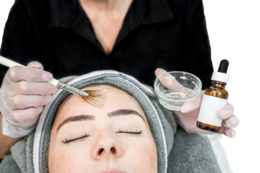 Provider putting a chemical peel on a young woman